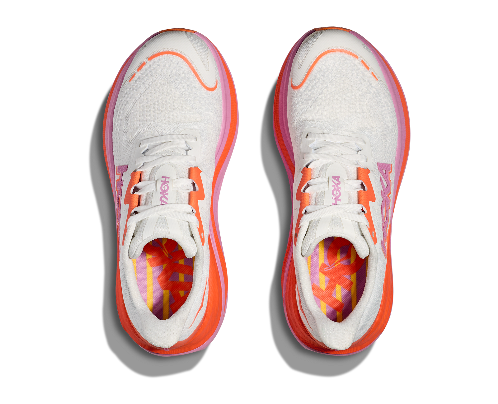 Hoka skyward x for women, super cushioned carbon plated running shoe, white colour with orange and pink details, top dow view of shoes