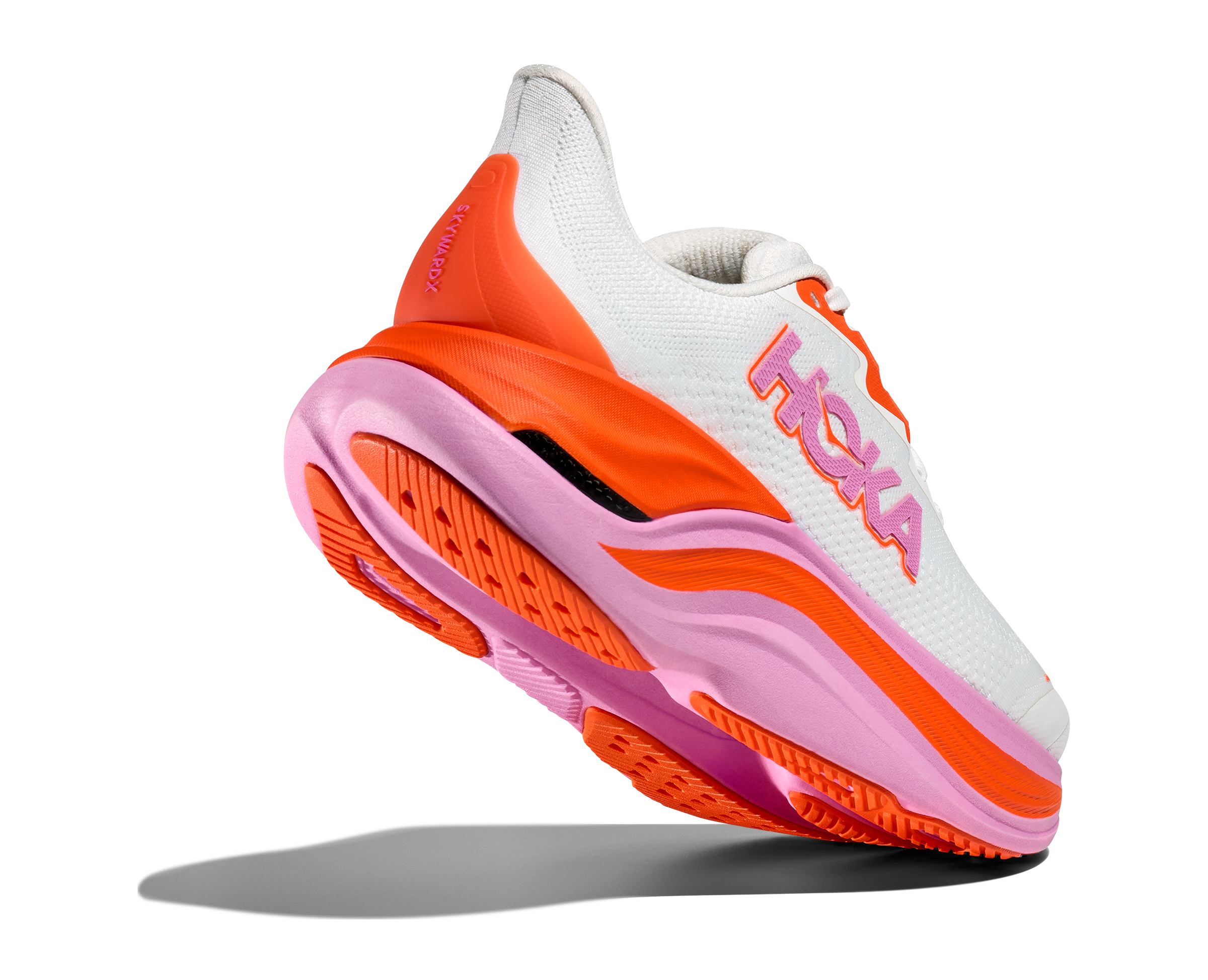 Hoka skyward x for women, super cushioned carbon plated running shoe, white colour with orange and pink details, shoe with heel lifted up showing sole