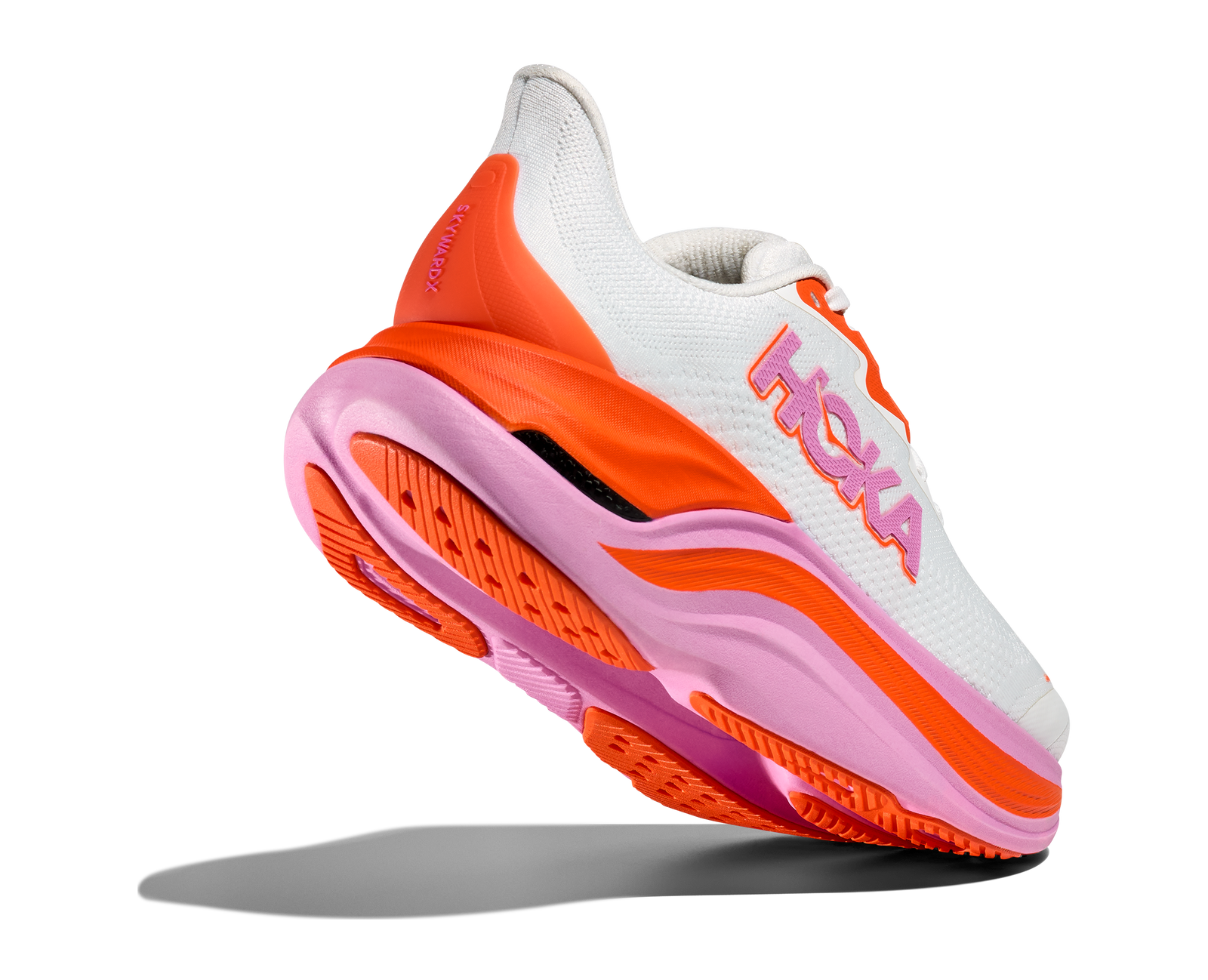 Hoka skyward x for women, super cushioned carbon plated running shoe, white colour with orange and pink details, shoe with heel lifted up showing sole