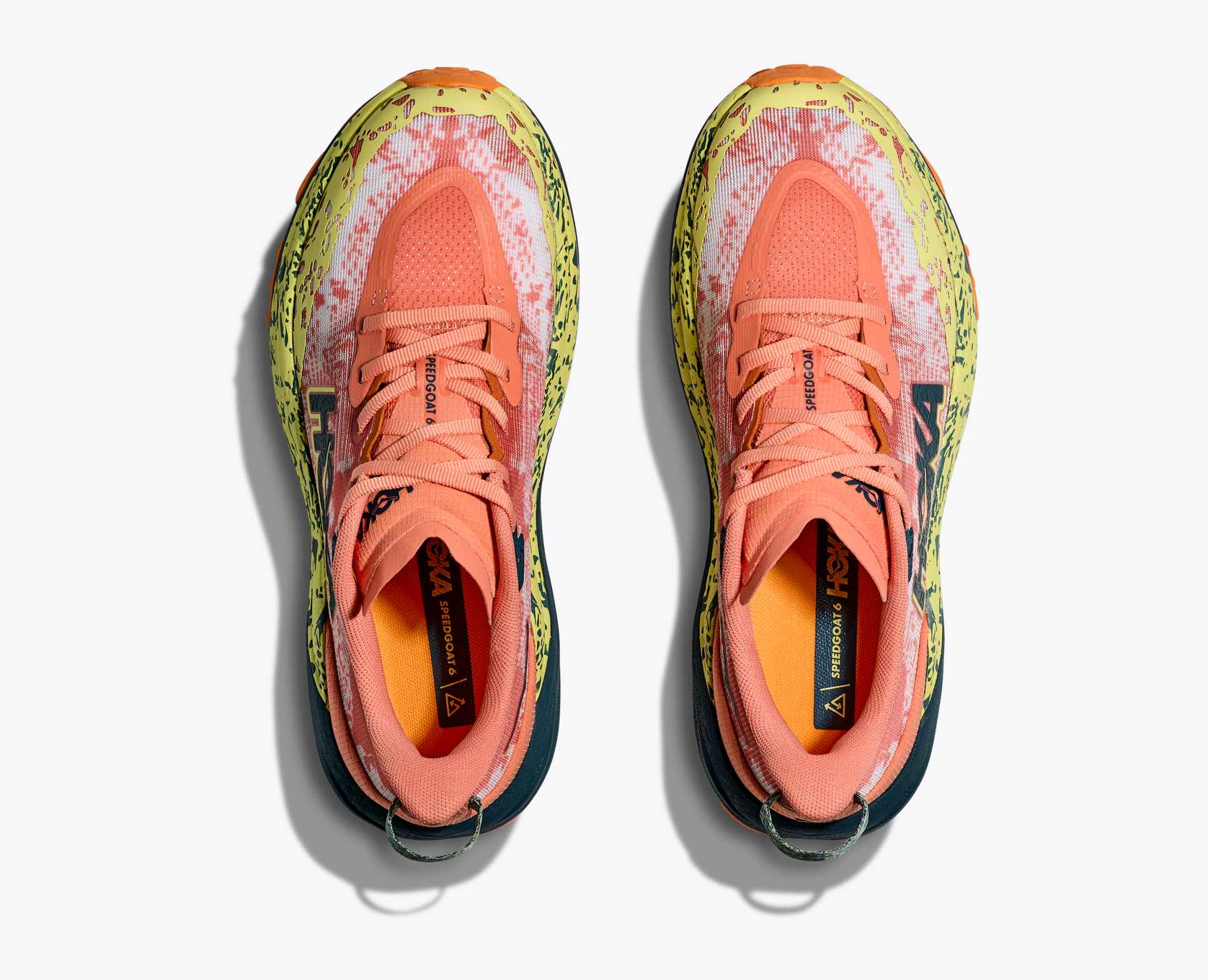 pair of orange hoka running shoe with yellow details