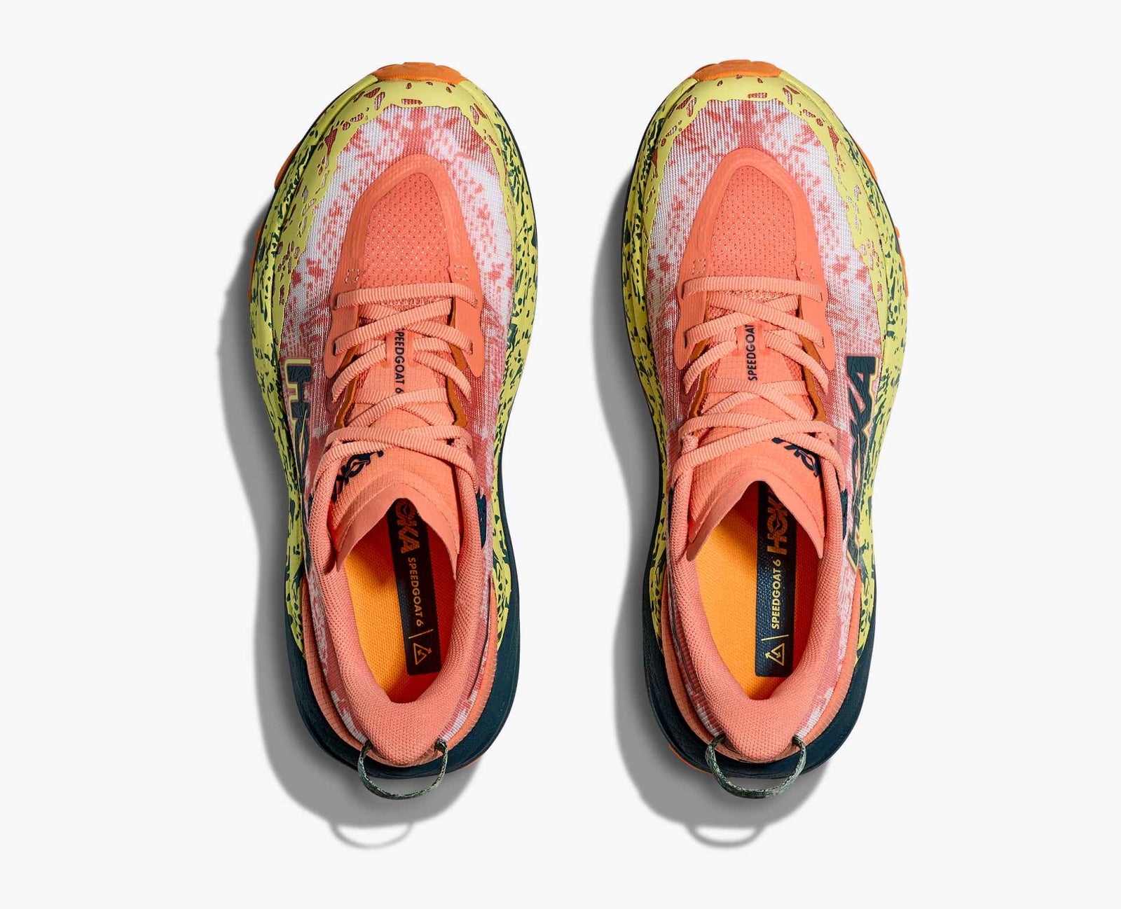 pair of orange hoka running shoe with yellow details
