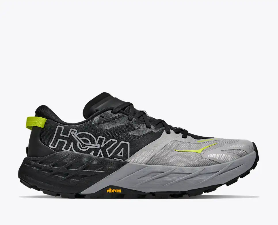 hoka speedgoat 7 for men, trail running shoe with vibrum sole, grey and black with lime green details, side profile of shoe