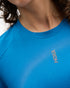 hoka everyrun short sleeve running t-shirt for women, blue colour with silver reflective logo, close up of woman wearing hoka tee with black shorts on a white background