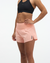 hoka womens glide short mr 3.5 brief, lightweight running short, solid peach colour, woman wearing short with black sports bra on white background