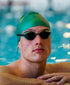 man wearing a green swim cap with the sage green huub eternal swim goggles in pool close up of face