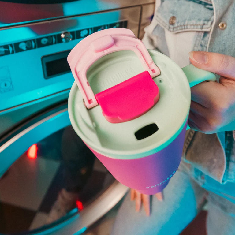 kambukka rio tumbler, 950 ml water bottler with handle and collapsable straw, pink colour with mint green accents, person holding tumber close up on lid