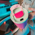kambukka rio tumbler, 950 ml water bottler with handle and collapsable straw, pink colour with mint green accents, person holding tumber close up on lid