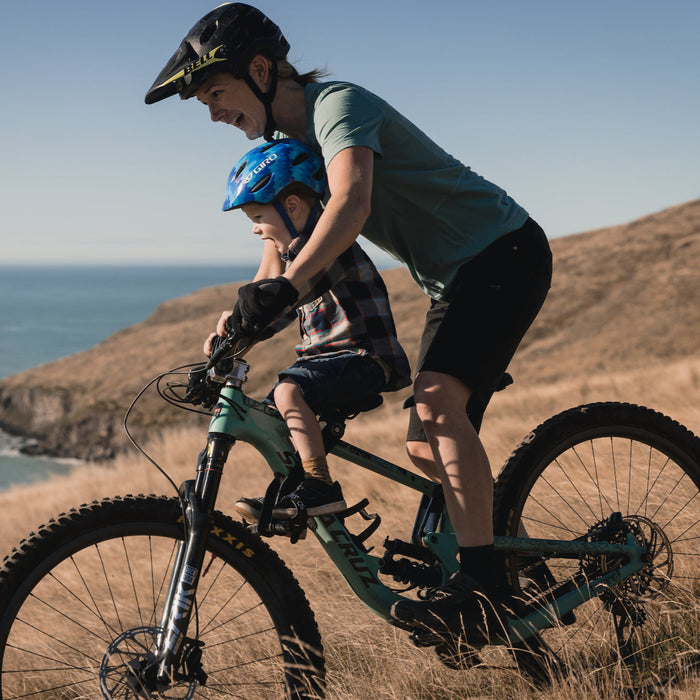 Kids Ride Shotgun 2.0 Child Bike Seat + Handlebars Combo, woman riding bike with child on hill with long grass
