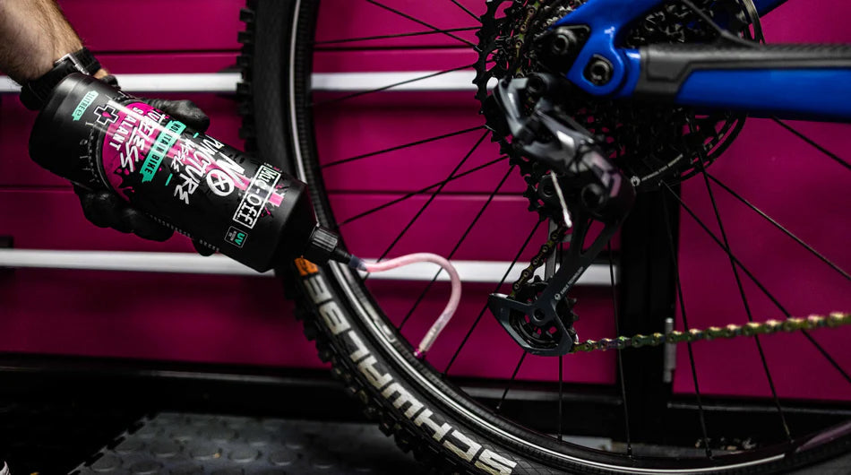 person using Muc off one litre no puncture hassle mtb tubeless sealant