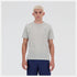 Man wearing a new balance gray run t-shirt and navy shorts on a white background