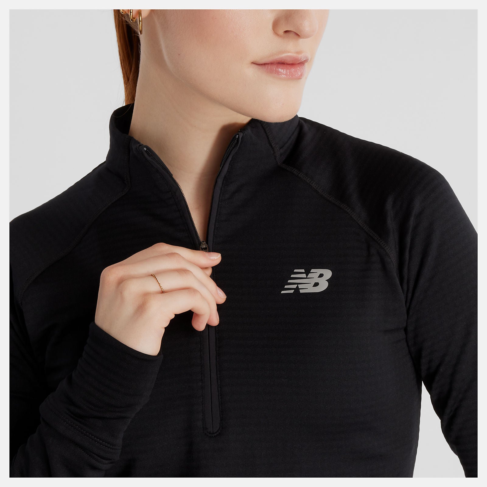 woman wearing nb heat grid half zip top showing zip