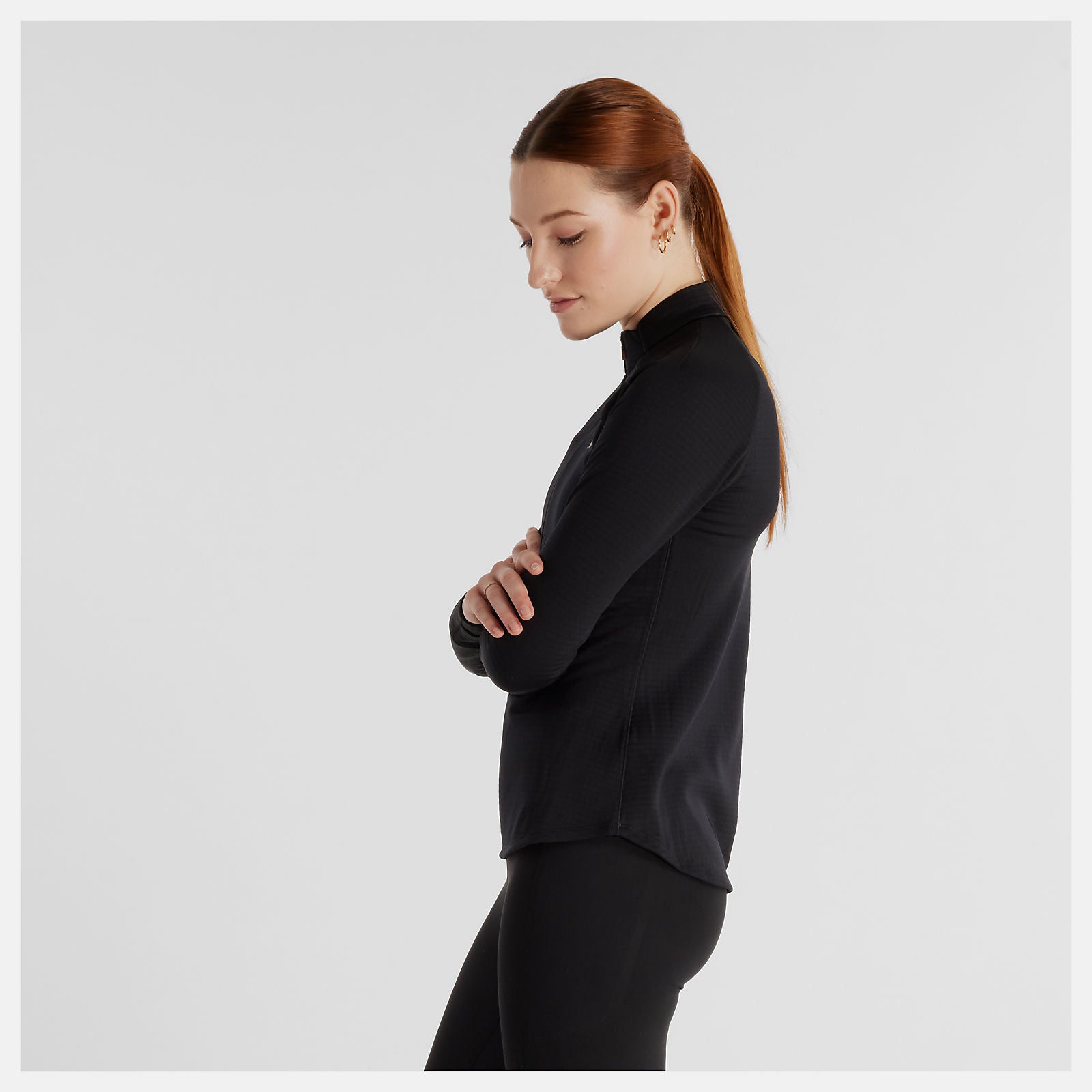 Woman wearing NB athletics half grid long sleeve run top