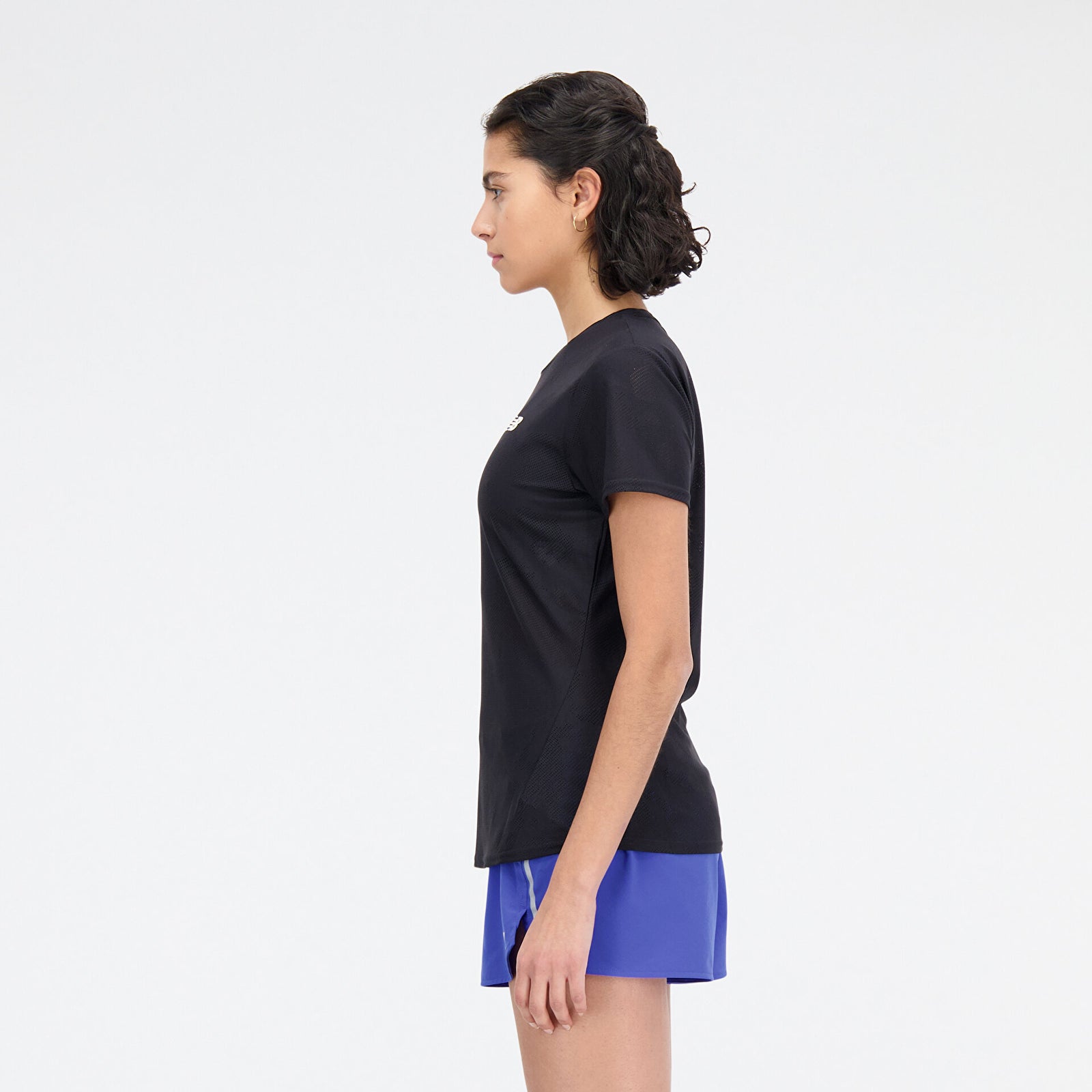 Woman wearing new balance jacquard short sleeve tee in black, side view