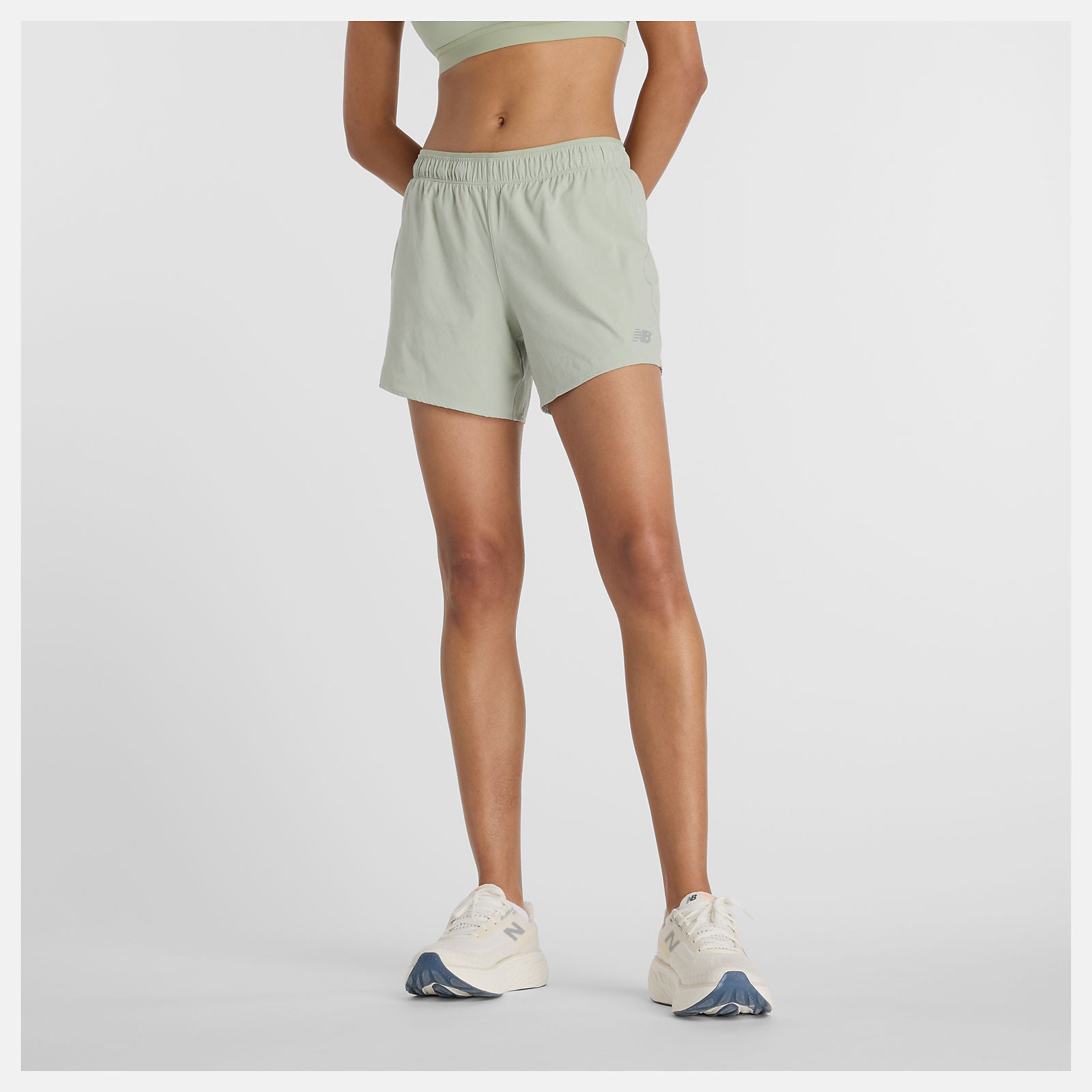 Woman wearing new balance 5 inch rc short in light green colour