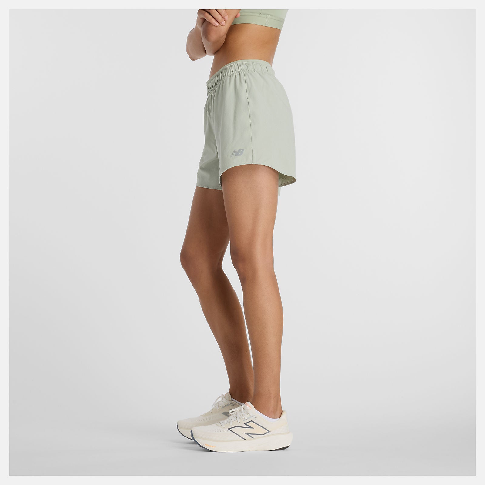 Woman wearing new balance 5 inch rc short in light green colour
