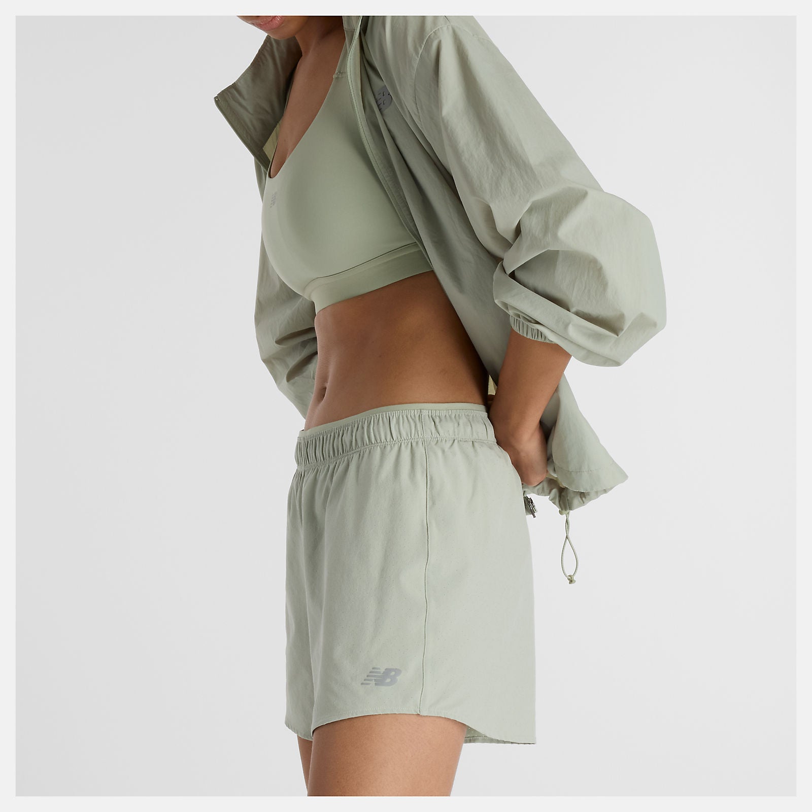 Woman wearing new balance 5 inch rc short in light green colour