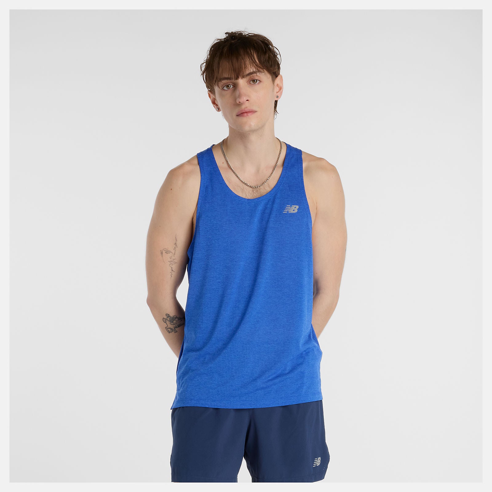 Person wearing a blue new balance running tank top and shorts 