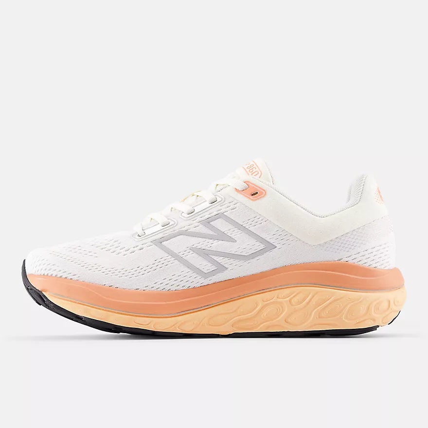 new balance white running shoe with orange sole for supportive running and walking inside profile