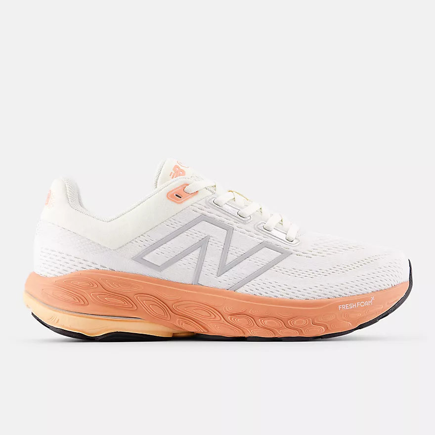new balance white running shoe with orange sole for supportive running and walking 