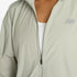 new balance athletics packable jacket for women, light wind breaker jacket that packs away into built in bag, light green colour, close up of zipper on nb jacket
