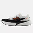 mens new balance fuel cell rebel version 5, light, bouncy daily trainer, white and black colour with orange details, side profile of runner on a white background