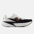 mens new balance fuel cell rebel version 5, light, bouncy daily trainer, white and black colour with orange details, side profile of runner on a white background