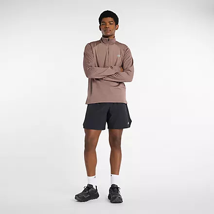 Man wearing new balance heat grid half zip run top in earth shadow colour
