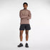 Man wearing new balance heat grid half zip run top in earth shadow colour