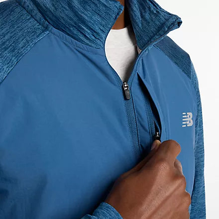 new balance athletics heat grid quarter zip for men, warm half zip running top, blue colour, close up on chest pocket zipper of blue running half zip