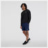 nb athletics long sleeve shirt for men, breathable long sleeve shirt good for layering, black colour, man wearing black nb long sleeve with silver nb logo and navy shorts and black new balance shoes