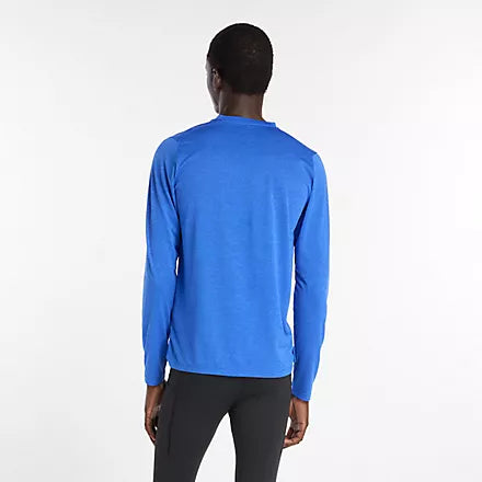 new balance athletics long sleeve shirt for men, lightweight breathable long sleeve top, royal blue colour, man wearing long sleeve blue nb top with black tights from behind