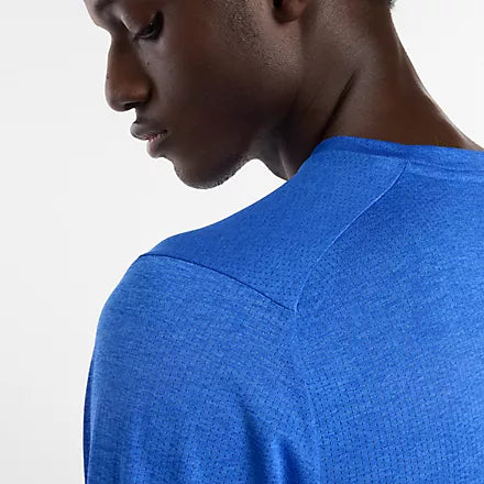 new balance athletics long sleeve shirt for men, lightweight breathable long sleeve top, royal blue colour, clos up of shoulder of man wearing long sleeve blue nb top