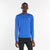 new balance athletics long sleeve shirt for men, lightweight breathable long sleeve top, royal blue colour, man wearing long sleeve blue nb top with black tights