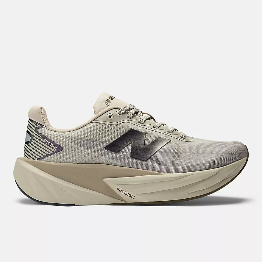 new balance rebel v5 for women, soft lightweight running shoe for short and long distances, light grey colour with beige sole and black logo, side profile of shoe