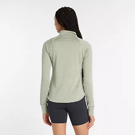 new balance athletics heat grid half zip for women, warm half zip running jumper, light green colour, woman wearing new balance running half zip from behind
