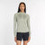 new balance athletics heat grid half zip for women, warm half zip running jumper, light green colour, woman wearing new balance running half zip with black short tights