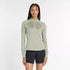 new balance athletics heat grid half zip for women, warm half zip running jumper, light green colour, woman wearing new balance running half zip with black short tights