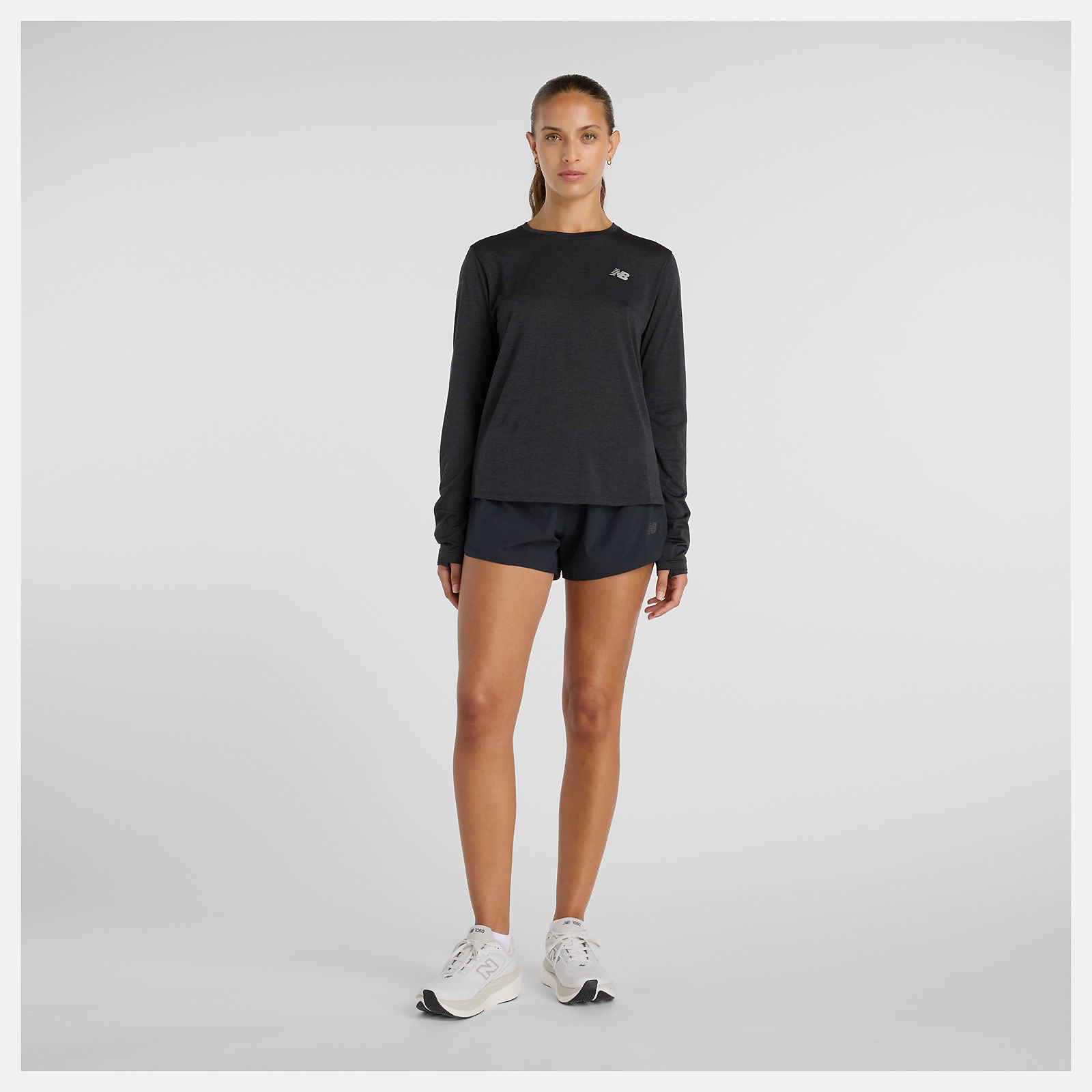 woman wearing NB athletics long sleeve run top in black