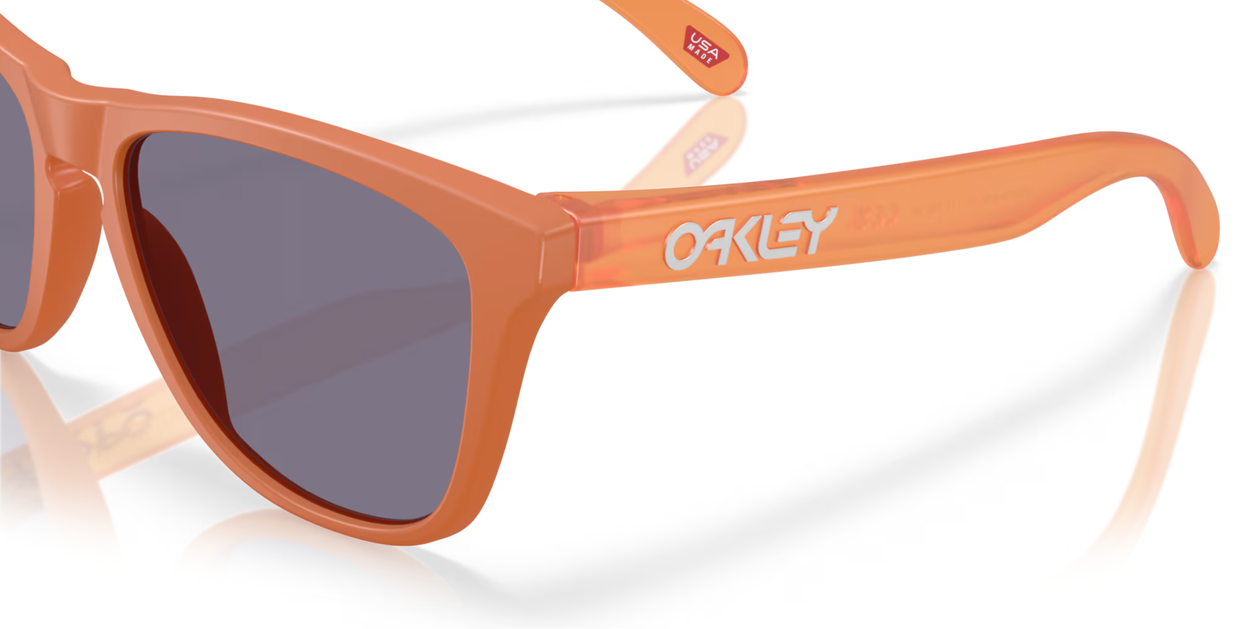 close up of arm of oakley frogskin sunglasses, classic style polarised sunglasses, orange frame with dark lense