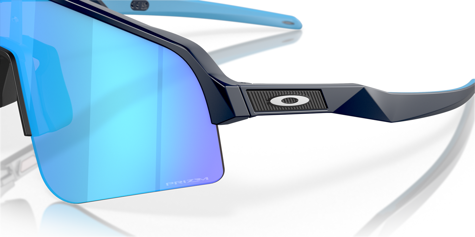 oakley sutro lite sweep sunglasses. A functional sport design with optimised coverage, extended field-of-view, retention and impact protection. navy frame with blue and purple lenses. close up view of lens and frame.
