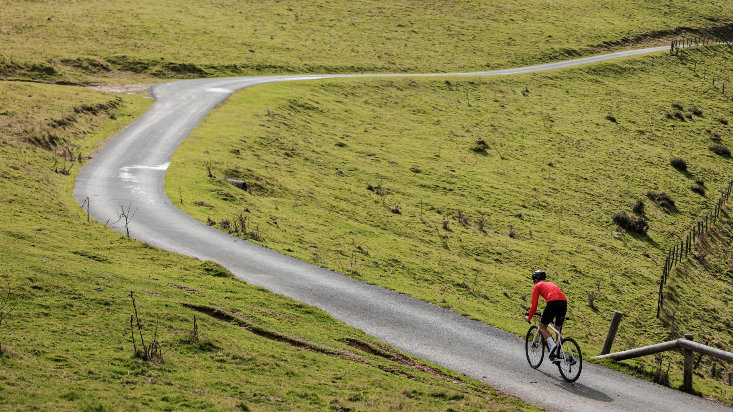 man cycling on the road on an orbea avant road bike
