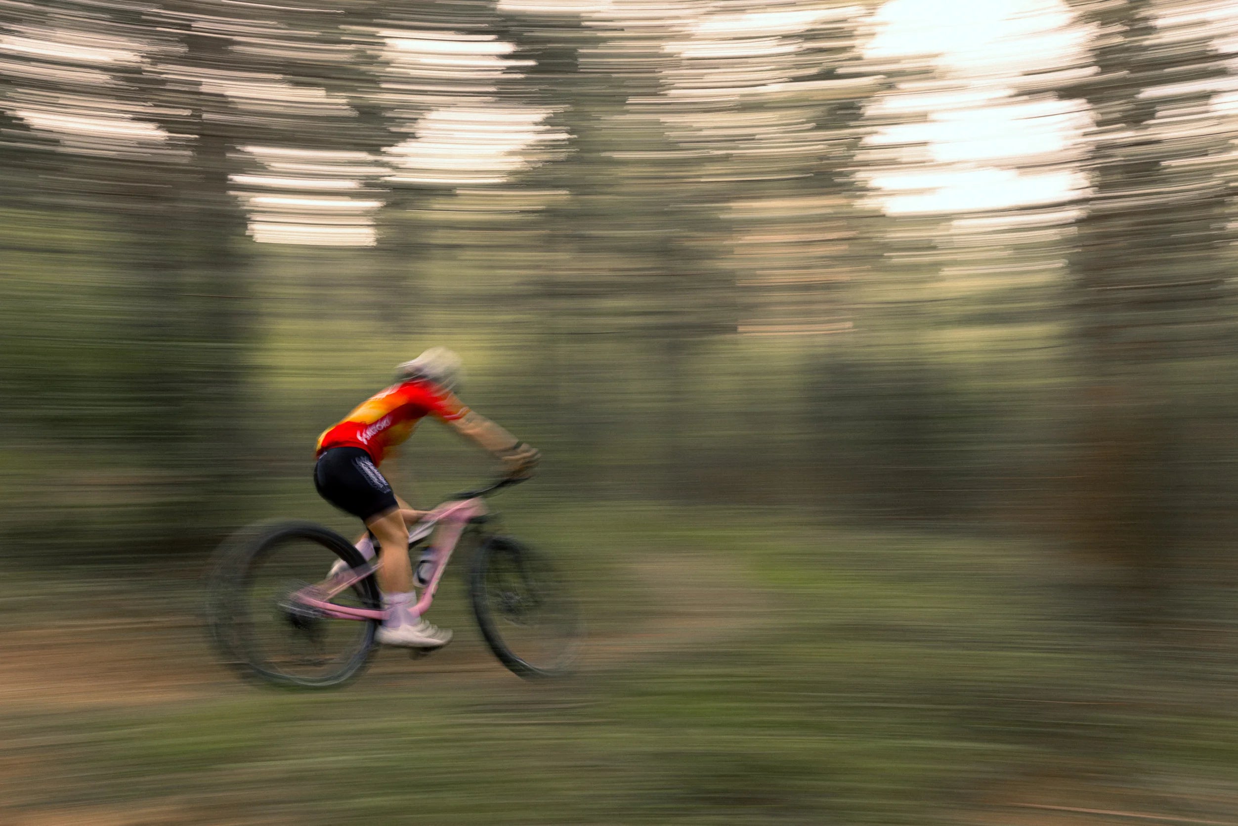 person racing through forest on an orbea oiz xc bike