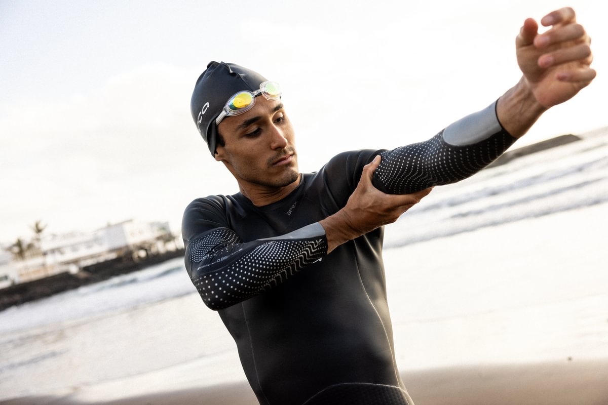 Man wearing Orca Apex Flow triathlon wetsuit showing flexibility in arms