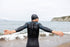 Man stretching arms before sea swim in Orca Athlex Flex, great wetsuit for flexibility