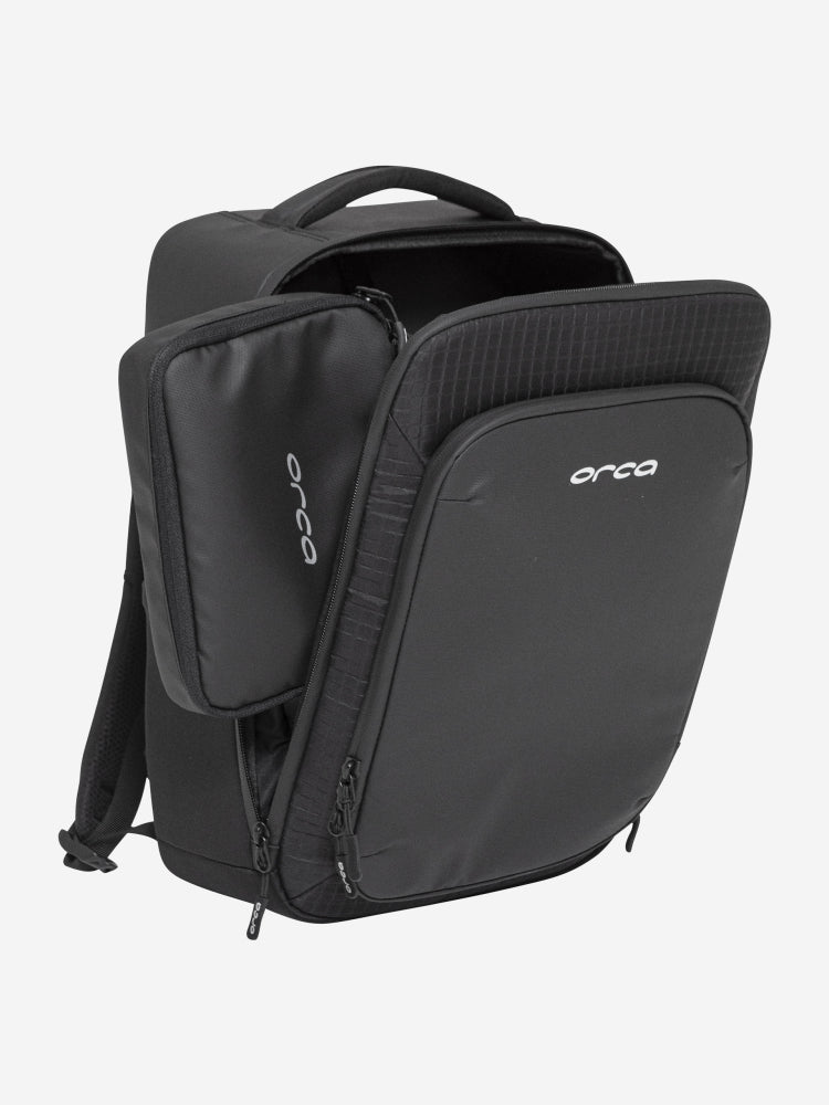 orca casual backpack in black, with soft and comfortable lower back support and space for a 15 inch laptop. Picture of side of backpack on white background.