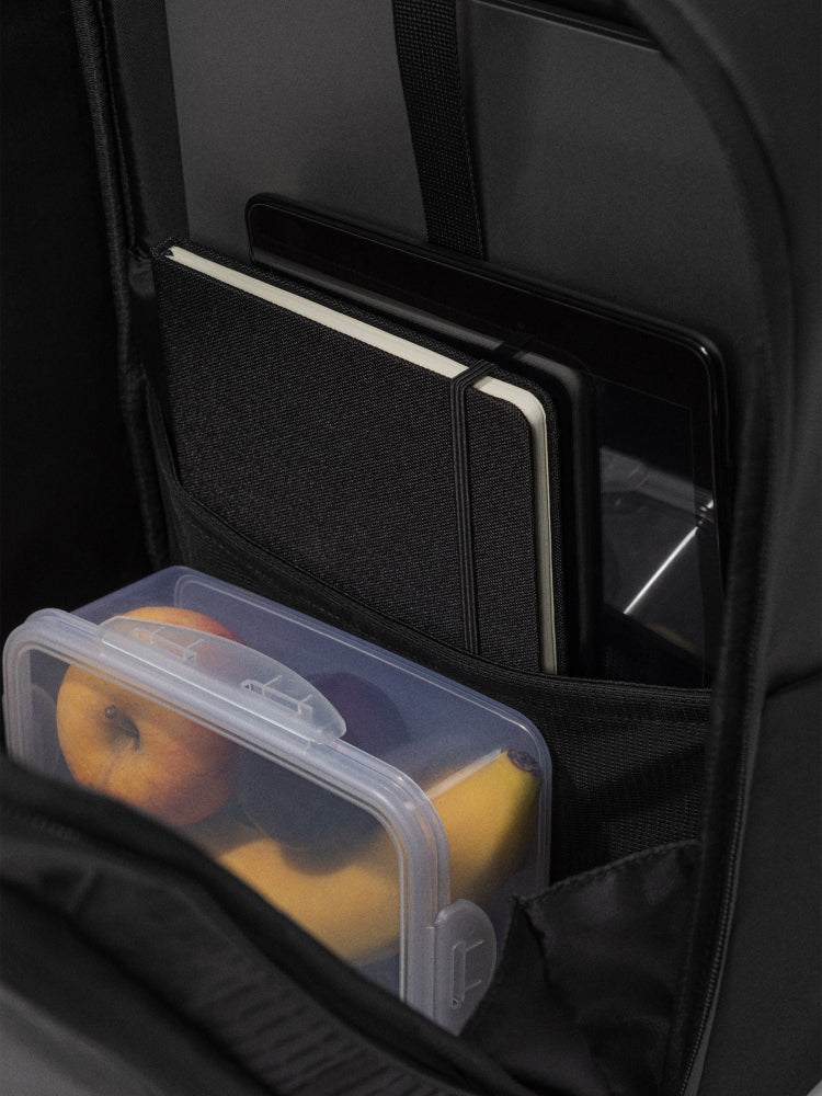 orca casual backpack in black, with soft and comfortable lower back support and space for a 15 inch laptop. Picture of inside of backpack on white background.