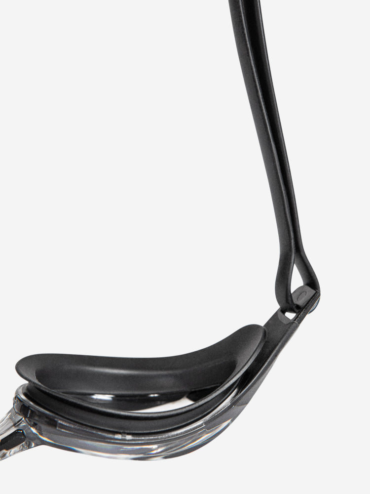 orca killa performance goggle, slim versatile swimming goggle for sea or pool, clear lenses with black silicone, close up of side of goggle