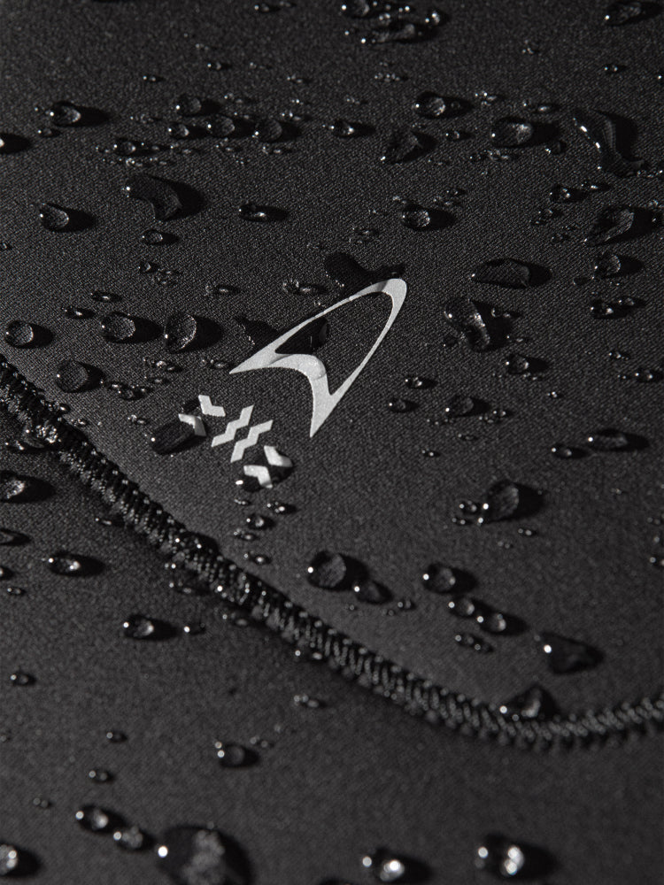 Close up of Orca Tango 5:4 surfing wetsuit for men showing water droplets running off the yamamoto neoprene