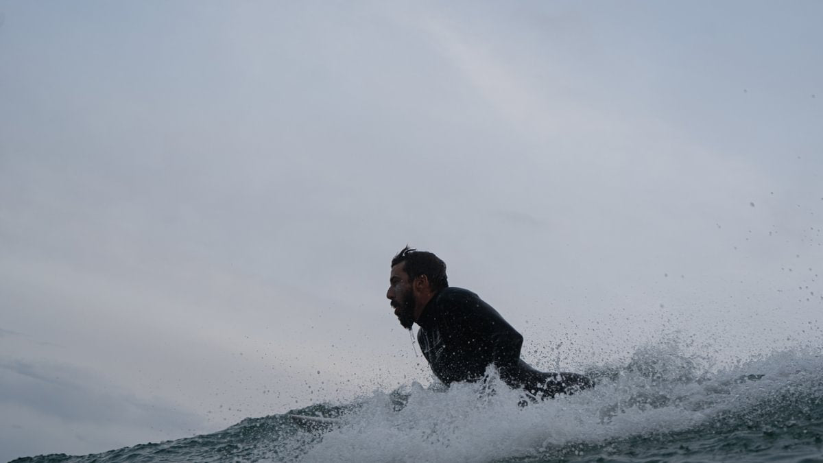Man surfing in Orca Tango 5:4 surfing wetsuit 