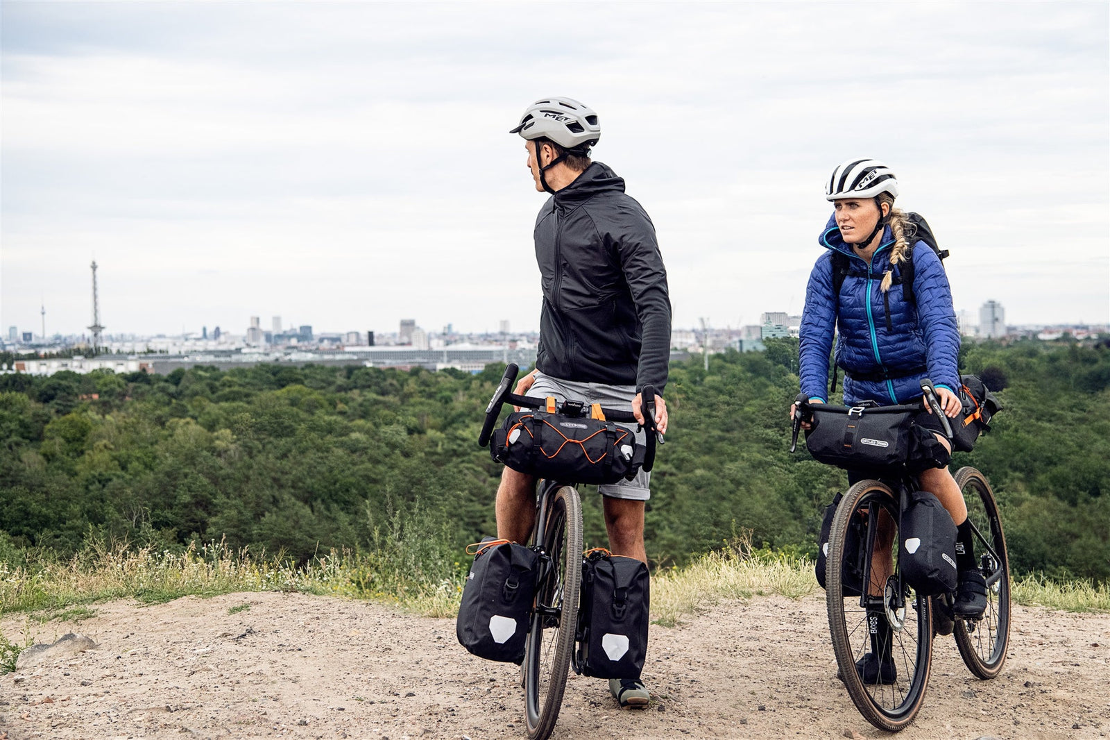 Two cyclists on a dirt path with ortlieb bicycle panniers and bags